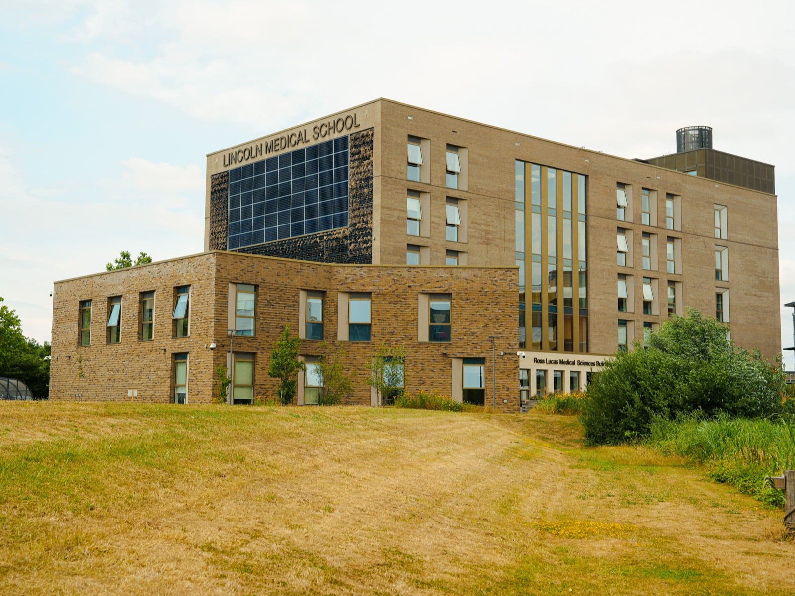 Lincoln Medical School, a brick building with a large solar panel array on its upper facade